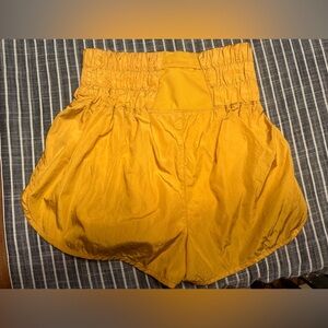 Three people movement, high wasted mustard colored shorts